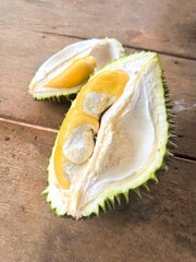 Fresh durain pulp on wooden table. Half of the durain fruit.