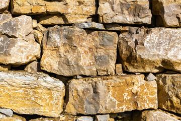 Stone wall fence in daylight. Banner background, backdrop or texture.