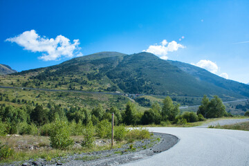 A mountain range with a road that runs through it