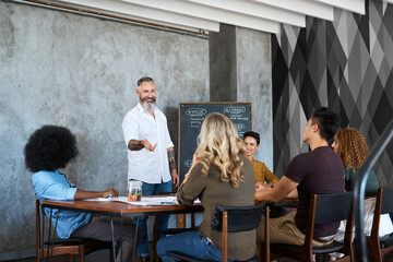 People, blackboard or mature man in presentation for teaching, change or skill development in meeting. Business workshop, value or mentor speaker talking in training, coaching or learning opportunity