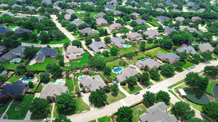 Large lot house with swimming pool, upscale two story suburban single family home lush green trees, Southlake suburbs Dallas Fort Worth metro complex, aerial residential neighborhood urban sprawl © trongnguyen