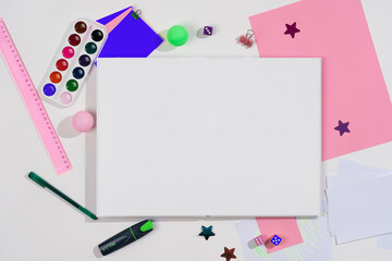 layout on a white table, mockup book with a clean spread and stationery, school background