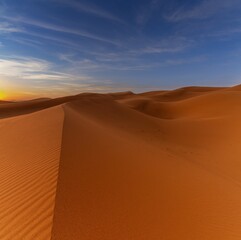view of the sand dunes at Erg Chebbi in Morocco in warm evening light
