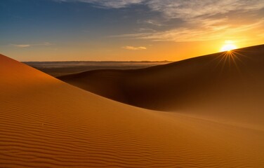 view of the sand dunes at Erg Chebbi in Morocco at sunset with a sunstar