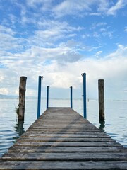 Fototapeta premium wooden bridge on the lake shore, wooden pier in the sea