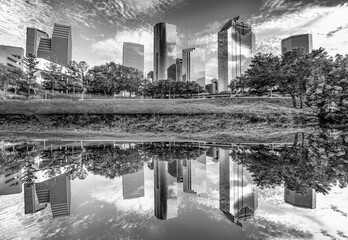 skyline of Houston, Texas in morning light seen from Buffalo bayou park and reflection in river