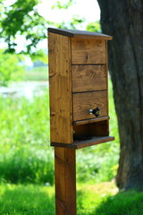 Wooden bird feeder in a park in the Lower Town of Gdansk