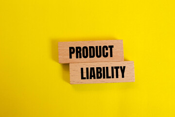 Naklejka premium Product liability message written on wooden blocks with yellow background. Conceptual product liability symbol. Copy space.