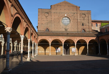 Fototapeta premium The Basilica of Santa Maria dei Servi stands along Strada Maggiore and is an example of Gothic architecture with the colorful buildings of Bologna around it.