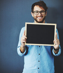 Smile, portrait and man with blackboard for mockup space with marketing, promotion or advertising....
