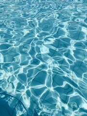 Water ripples on sunny day in the blue tiled pool