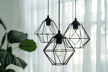 Modern black pendant lights with vintage light bulb in a modern house interior. Hanging ceiling light in a white shared office space. Decorative geometric metal lamp. Suspended chandelier loft style