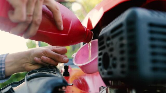 changing the engine oil in a lawn mower, servicing the lawn mower.