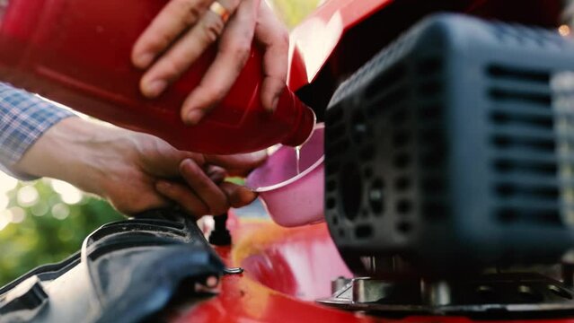 changing the engine oil in a lawn mower, servicing the lawn mower.