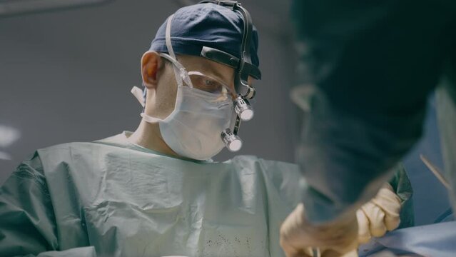 Two doctors in uniform mask physician medic man surgeon medical nurse perform surgical operation emergency help in hospital clinic plastic surgery transplantation operate patient health medicine aid