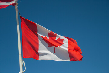 You are looking at the Canadian flag. It is red and white and contains a maple leaf in the centre
