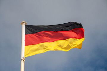 The federal flag of Germany. It consists of three horizontal stripes in black, red and gold or yellow.