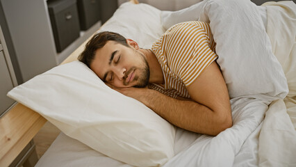 A young hispanic man with a beard sleeps peacefully in a bedroom, showcasing a serene indoor scene.