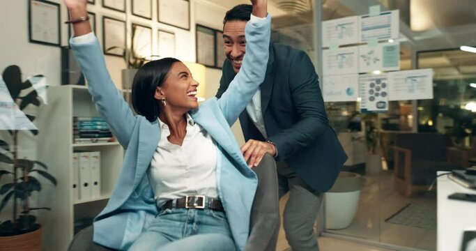 Happy, business people and playing with chair at night for fun energy, celebration or deadline completion at office. Young businessman and woman enjoying late free time, done or finished at workplace