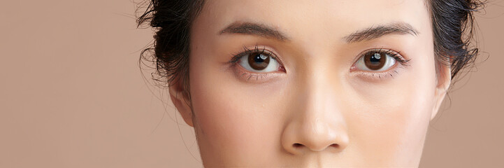 close up of beauty asia woman eye on beige background