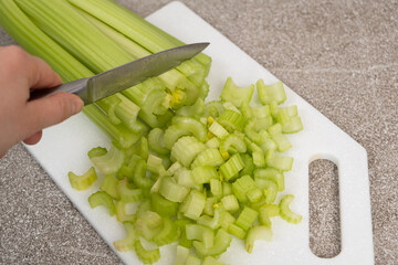 The Process of Slicing Green Celery Stalks.