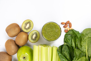 Healthy Vegetable Fruit Nut Green Smoothie in a Glass on a White Background.