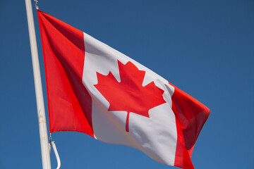 You are looking at the Canadian flag. It is red and white and contains a maple leaf in the centre