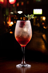 drink alcoholic cocktail with silvestry blackberry and mint on wooden table blurred bar background