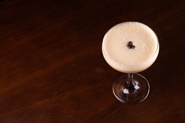 Irish cream drink glass with coffee falling into the cocktail glass in top view