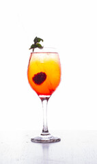 tropical cocktail glass with red blackberry fruits on white background