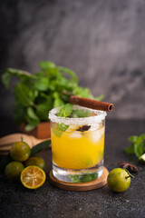 Fresh summer orange mojito with tangerine orange, mint and ice on black background