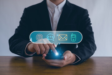  Businessman  touching on virtual screen with the email,  address, call phone, Chat message icons. Customer support hotline Contact us people connection.