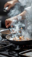 A chef is cooking food in a pan with smoke coming out of it