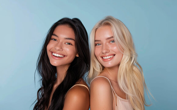 Beautiful smiling young women with healthy shiny long hair	