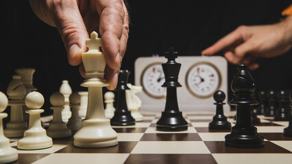 Close up of hand holding chess on chess board