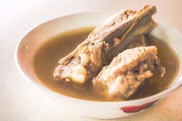 Bak Kut The Pork Rib with 2 shorter pork ribs in a peppery soup