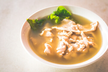 sliced lean pork with lettuce in a peppery pork soup
