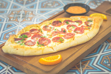Pide Pepperoni Freshly made pide with Turkish sun-dried salami and mozzarella