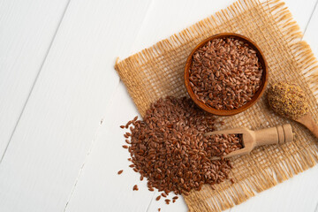 Heap of raw flax seeds and crushed flaw seed on wood table,Healthy and rich in fibre for weight management.
