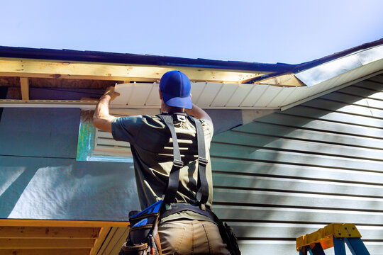 Plastic soffits mounted to roof rafters on house with cathedral ceiling