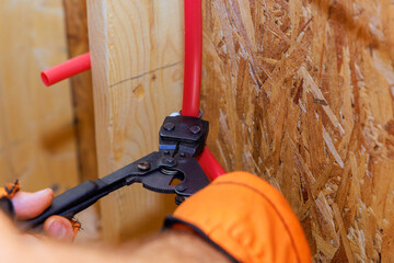 Assemble installation of PVC plastic water pipes in wall of residence by plumber