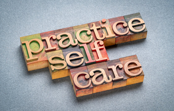 practice self care - text in retro letterpress wood, health and lifestyle concept