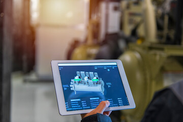 professional digital tablet. person holding a tablet computer on chiller Plant background. Industrial interior chiller and boiler HVAC heating ventilation air conditioning system.