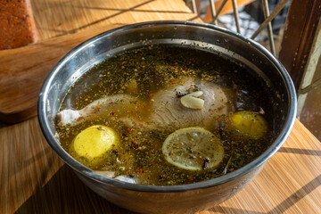 Soaking the chicken in a brine solution using lemon, herbs and aromatic