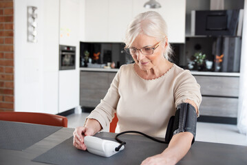 Senior woman measuring blood pressure
