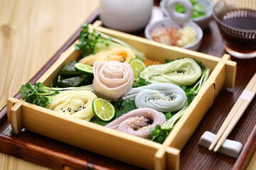 Japanese thin noodles made of wheat, called somen.  Chilled summer food. with pork shabu shabu.  Usually somen noodles are white, but this is a colored version.