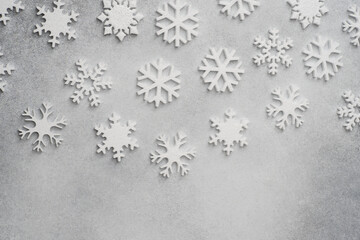 White snowflakes on a gray background