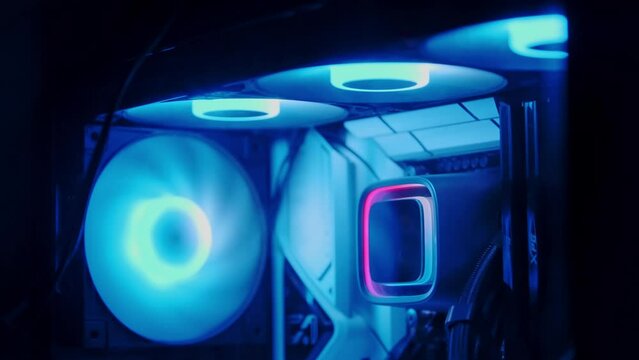 Inside view of a custom gaming PC with vibrant rainbow RGB LED lighting. Computer equipment.