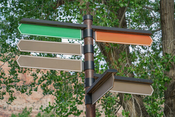 direction road sign in city under tree