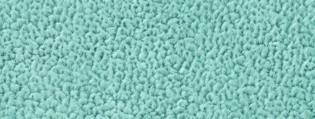 Texture of cyan fluffy woolen textile background from soft fleecy material, macro. Structure of turquoise fabric © nikol85